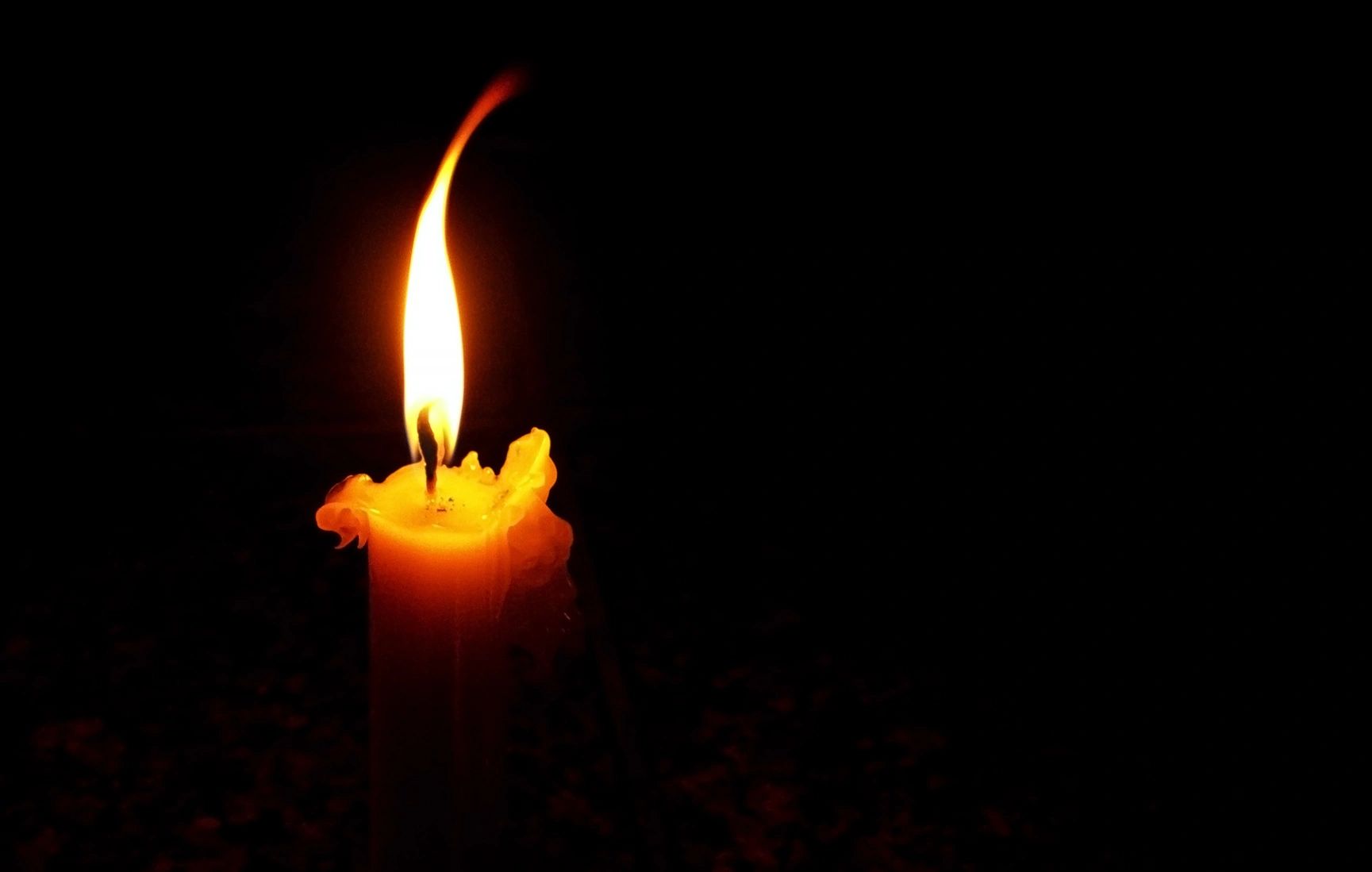 A Candle Lighting In The Dark